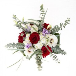 Describing this bouquet is to narrate a story of confident artistry and genuine warmth, much like the character of Sutton itself. Elegant white gerberas stand as anchors, their creamy petals fanning out from deep brown centers, flanked by velvety red roses whose lush spirals suggest enduring connection and heartfelt sincerity. Lisianthus offer a playful twist with their lilac and lavender tones, some unfurling softly, others remaining in elegant bud, capturing a moment between anticipation and arrival. Overhead, slender arcs of eucalyptus leaves create gentle motion, their silvery-green tones and subtle aroma reminiscent of strolls through Sutton's gardens. The bouquet is built upon generous, dark green foliage that supports and elevates the blooms, and fluffy clusters of white filler flowers lend an ethereal quality. Housed in a clear glass vase, the submerged stems remain visible, reflecting the honesty and grounded beauty of the arrangement. This piece is a fitting choice for commemorating anniversaries, delivering comfort, or marking new beginnings-its freshness and harmonious design a celebration of local florist tradition, crafted with care for all corners of Sutton.